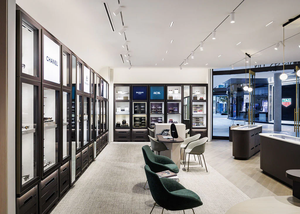 A room with a display case and chairs.